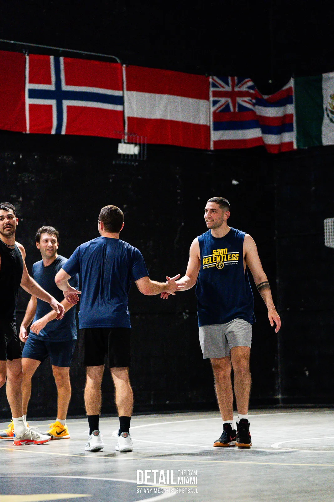 A full group of adults on the court between runs